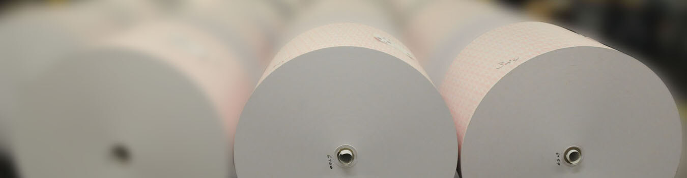 Thermal paper rolls staged on the production floor